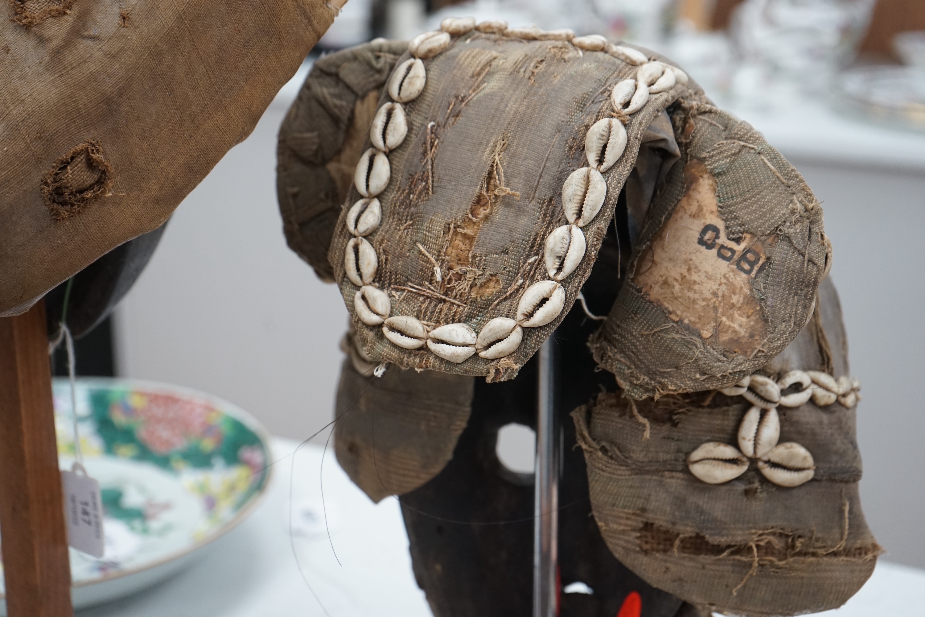 An African Ivory Coast/Liberian Dan mask together with another from the Democratic Republic Congo, both on stands, tallest 58cm including stand. Condition - some damage to the fabric of hats